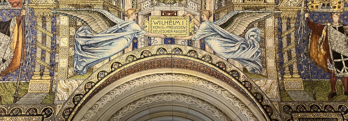 Zwei Engel in einem Bild halten ein Schild, auf dem der Name Wilhelm I. steht.